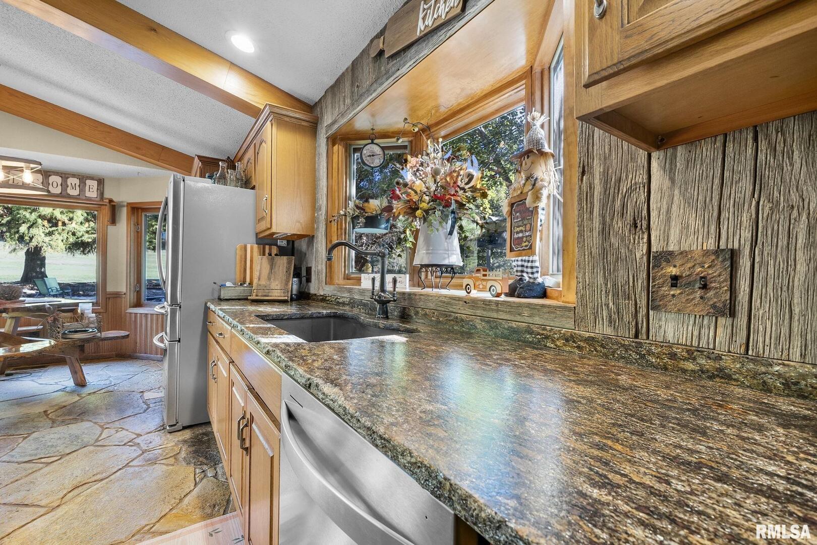 1810 Berryville Road Jonesboro, IL 62952 - Photo 22 of 60 a kitchen with stainless steel appliances granite countertop a sink and a counter space