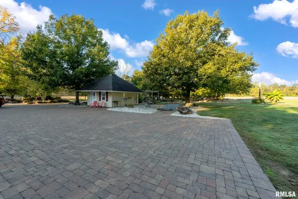 a view of a house with a yard and a garage