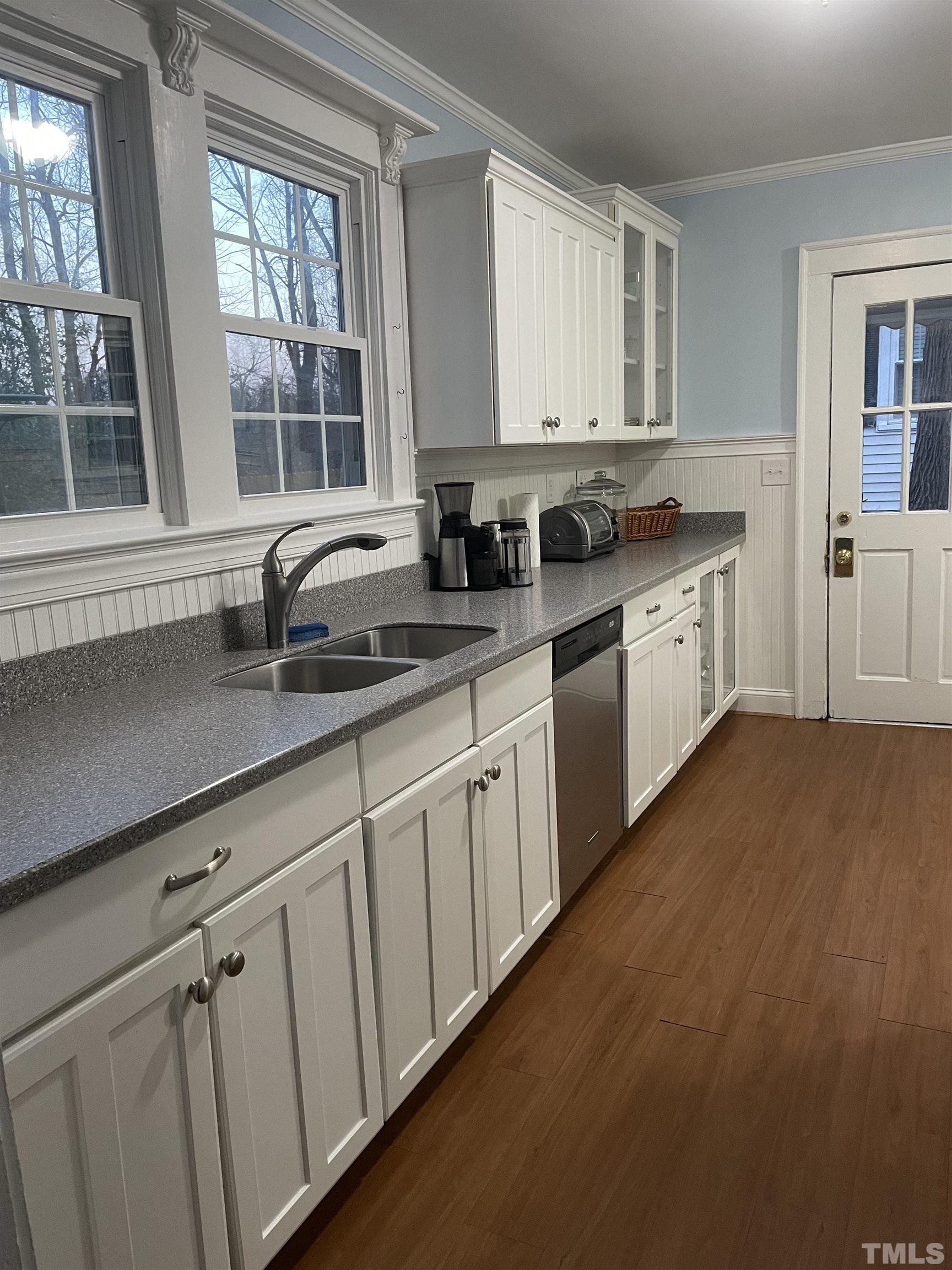 101 East Riverside Drive Smithfield, NC 27577 - Photo 14 of 38 a kitchen with stainless steel appliances granite countertop a sink a stove cabinets and a window