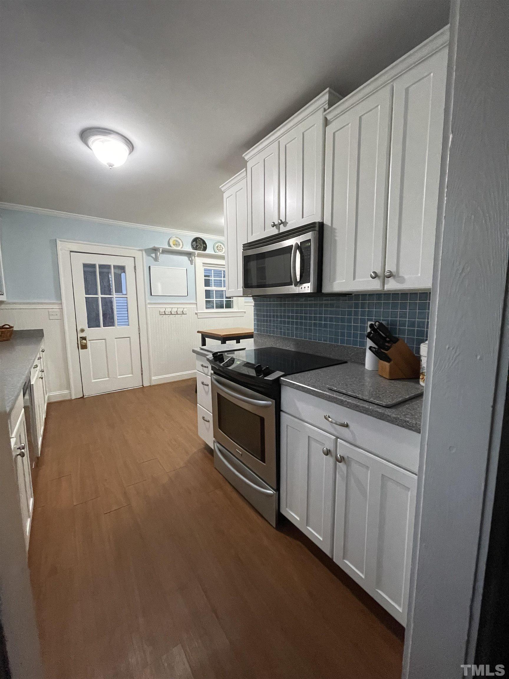 101 East Riverside Drive Smithfield, NC 27577 - Photo 15 of 38 a kitchen with stainless steel appliances granite countertop a stove a sink and a refrigerator