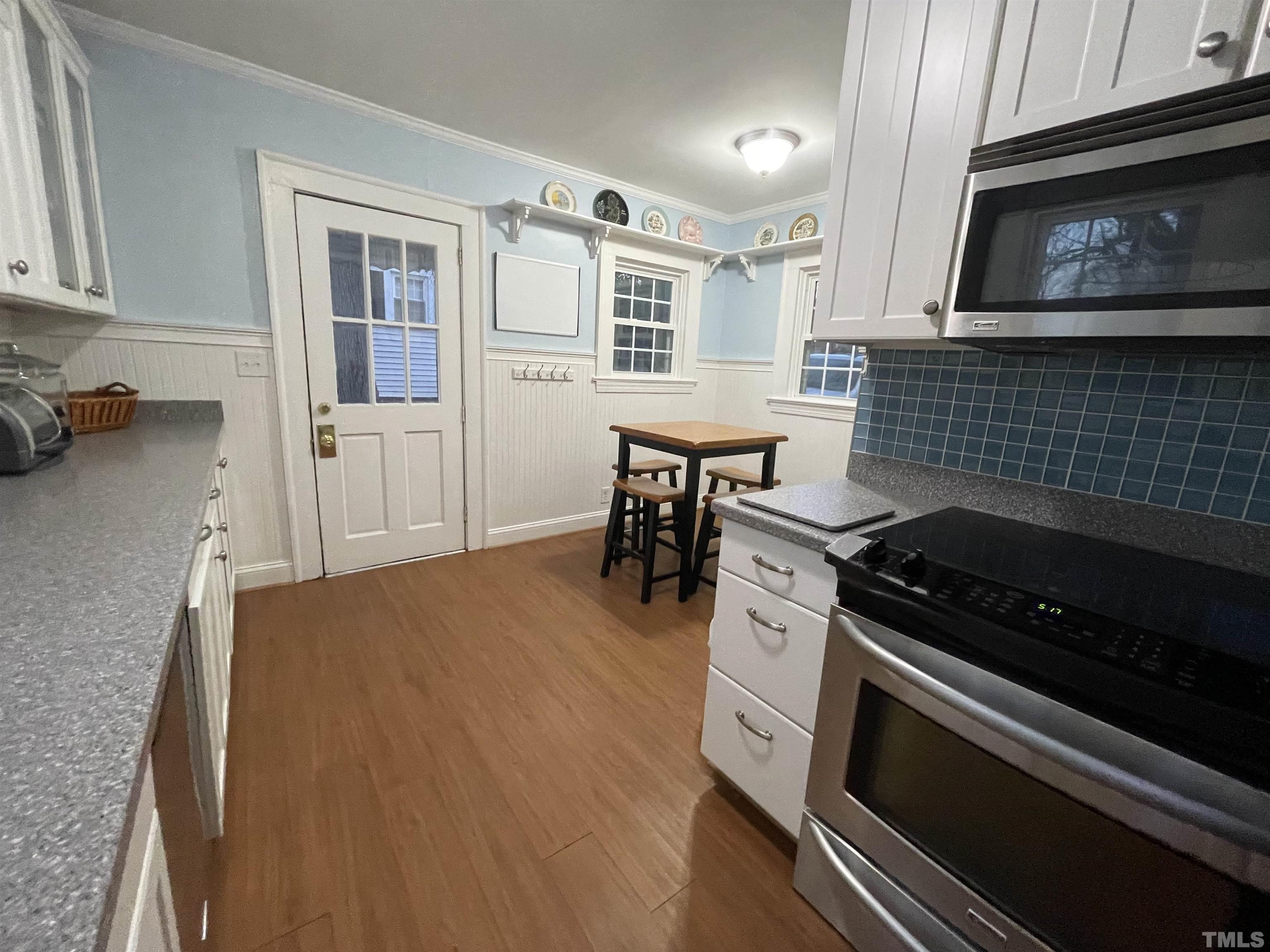 101 East Riverside Drive Smithfield, NC 27577 - Photo 16 of 38 a kitchen with a stove a microwave and wooden cabinets