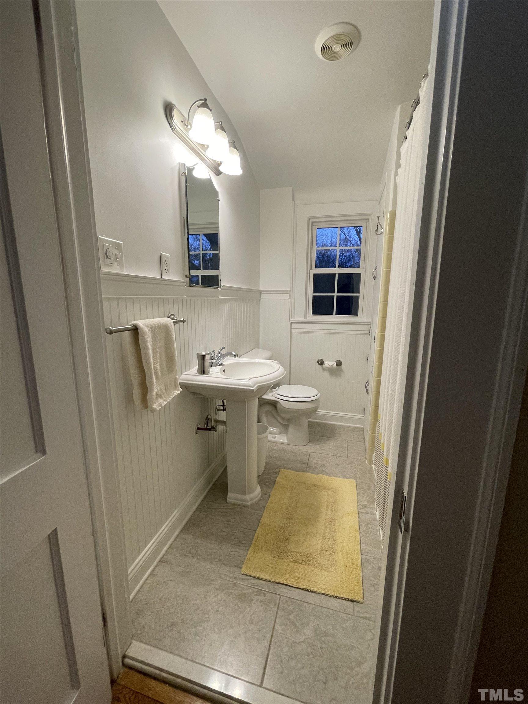 101 East Riverside Drive Smithfield, NC 27577 - Photo 23 of 38 a bathroom with a sink a toilet and mirror