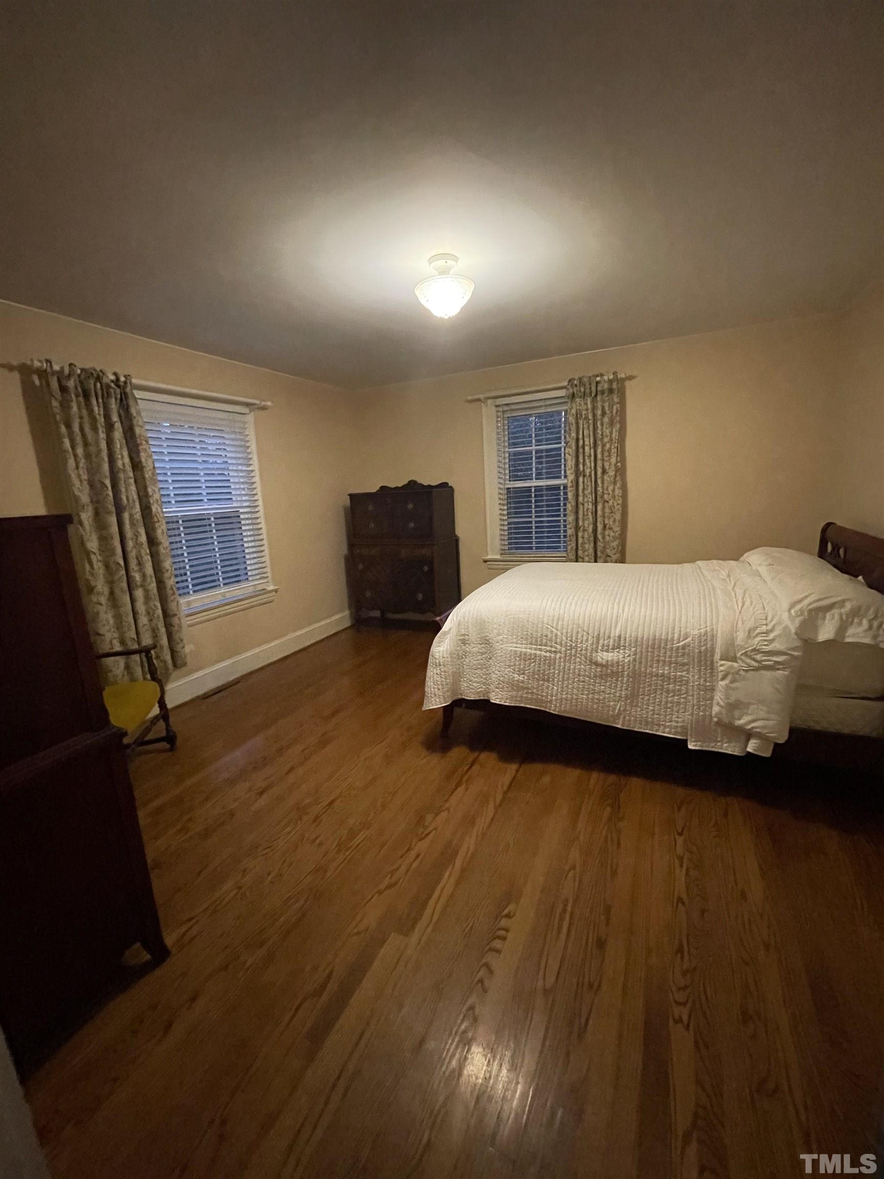101 East Riverside Drive Smithfield, NC 27577 - Photo 26 of 38 a bedroom with a bed and a dresser with wooden floor