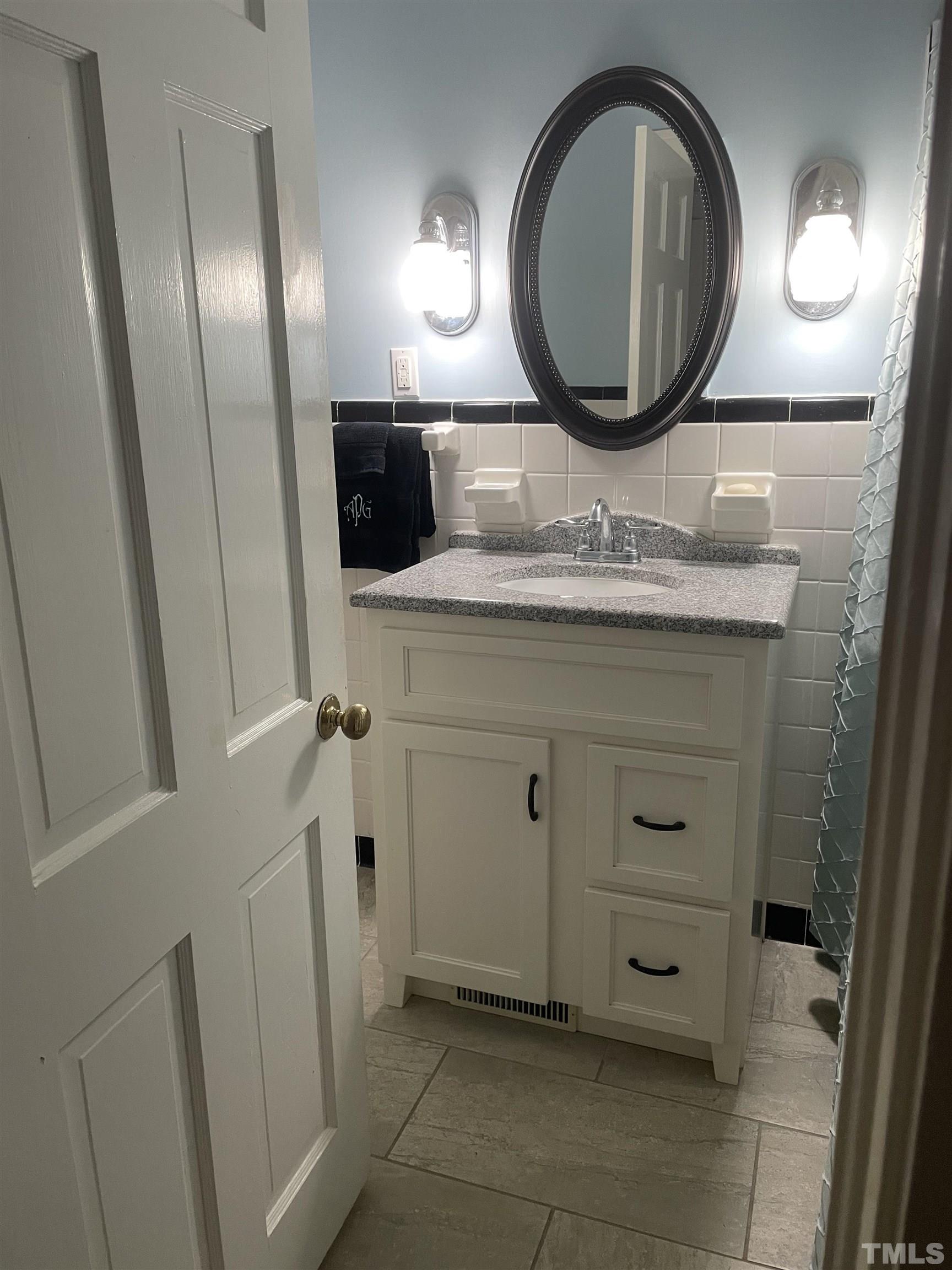 101 East Riverside Drive Smithfield, NC 27577 - Photo 27 of 38 a bathroom with a granite countertop toilet sink and mirror