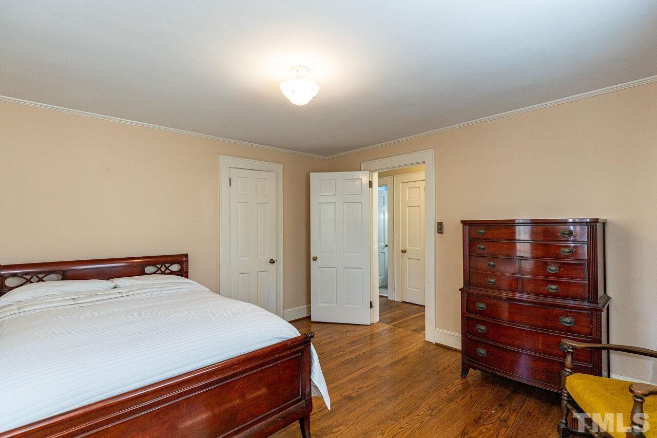 101 East Riverside Drive Smithfield, NC 27577 - Photo 29 of 38 a bedroom with a bed and wooden floor