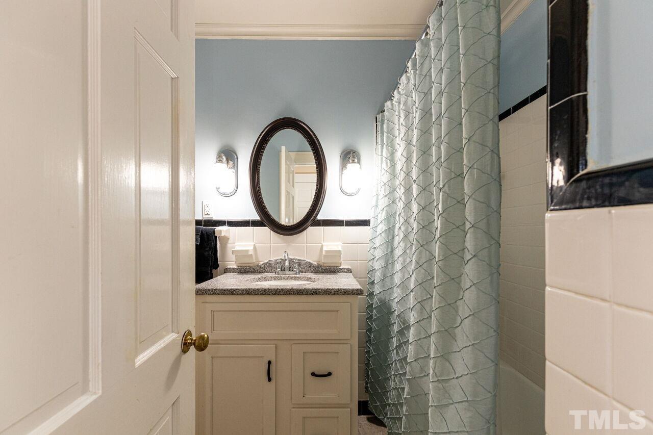 101 East Riverside Drive Smithfield, NC 27577 - Photo 31 of 38 a bathroom with a sink and a mirror