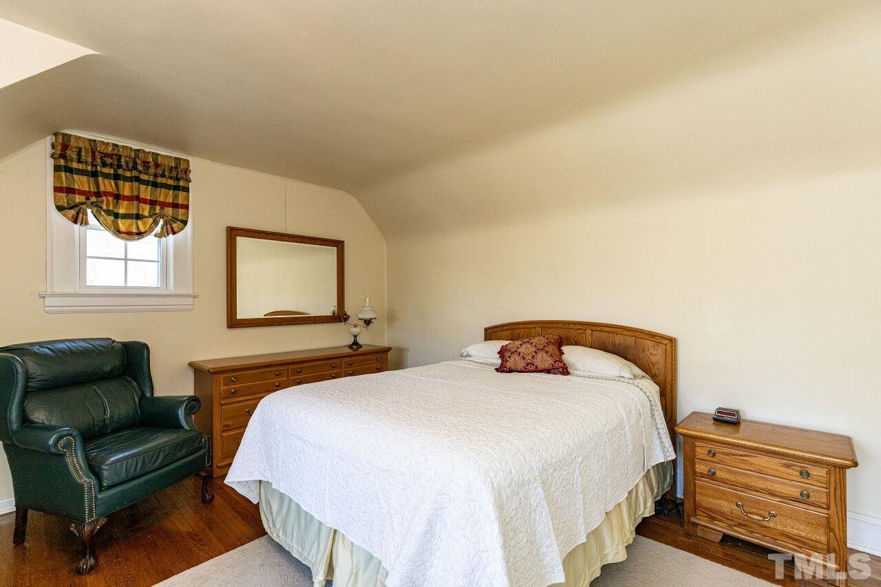 101 East Riverside Drive Smithfield, NC 27577 - Photo 32 of 38 a bedroom with a bed and a couch
