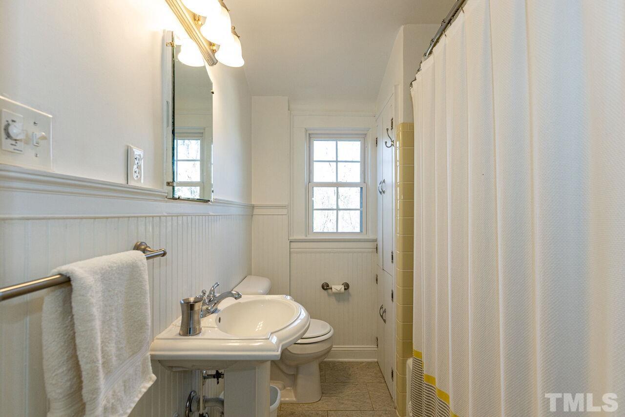 101 East Riverside Drive Smithfield, NC 27577 - Photo 36 of 38 a bathroom with a sink toilet and mirror