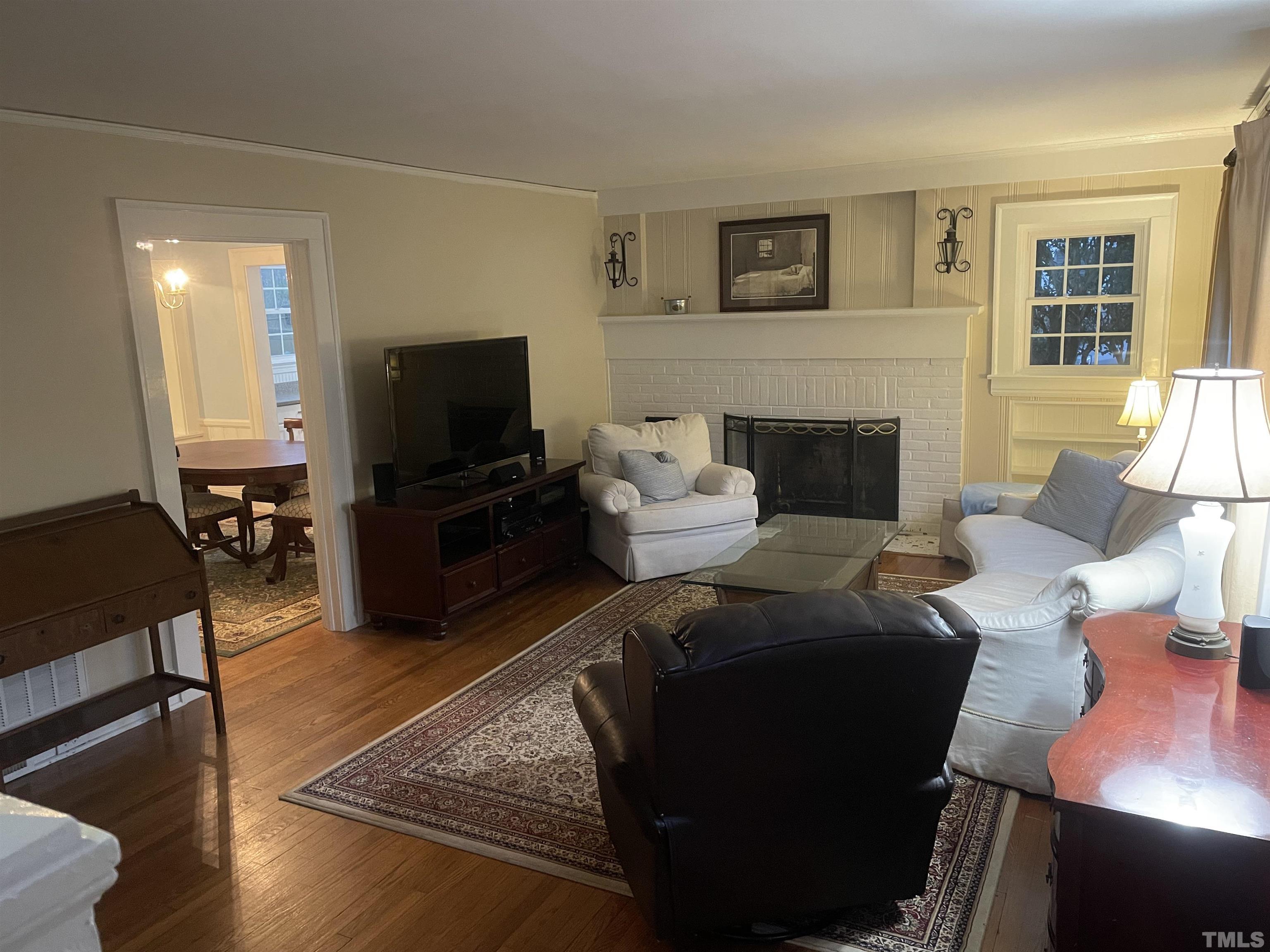 101 East Riverside Drive Smithfield, NC 27577 - Photo 8 of 38 a living room with furniture and a flat screen tv