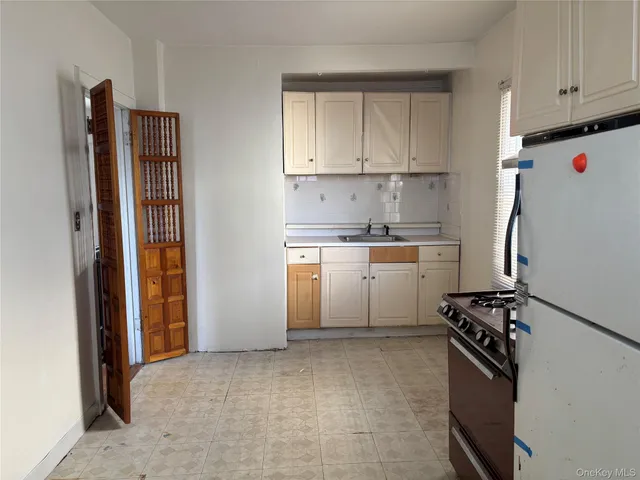 a kitchen with cabinets and appliances