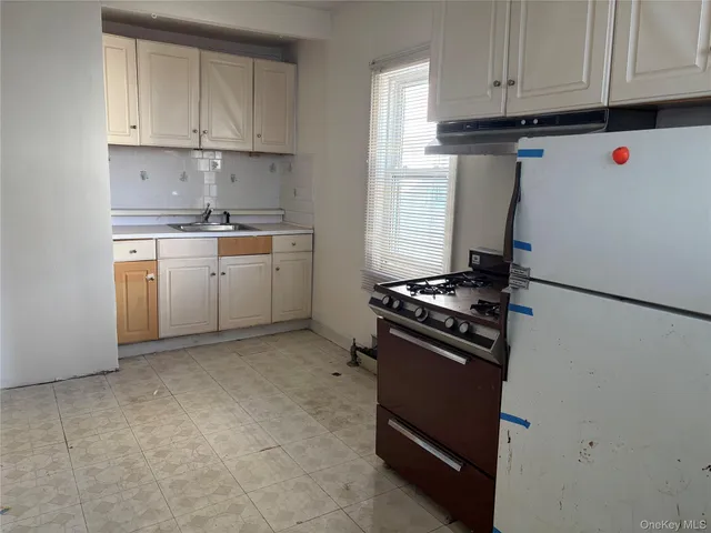 a kitchen with granite countertop cabinets and white appliances