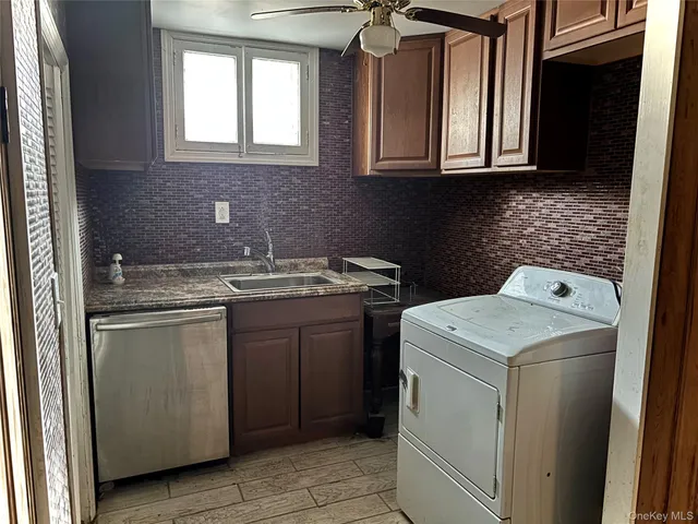 a kitchen with a stove sink and cabinets