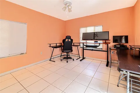 a work room with furniture and a flat screen tv