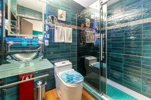 a bathroom with a sink toilet and shower