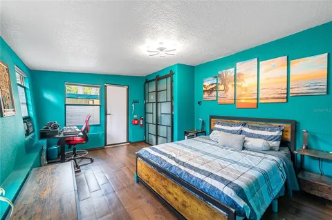 a bedroom with a bed window and a table