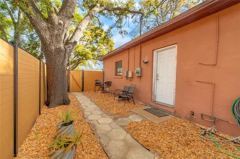 a view of backyard with a large tree