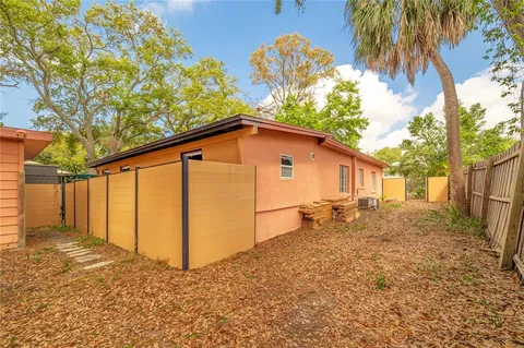a backyard of a house with table and chairs