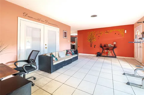 a living room with furniture and floor to ceiling window