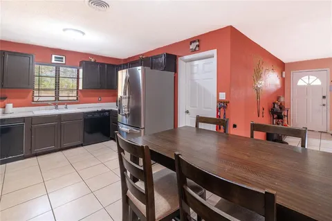 a kitchen with stainless steel appliances a sink counter space and a refrigerator