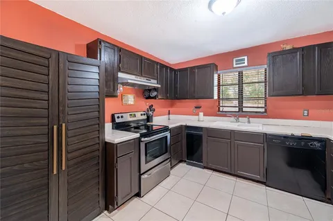 a kitchen with stainless steel appliances granite countertop a stove sink and cabinets