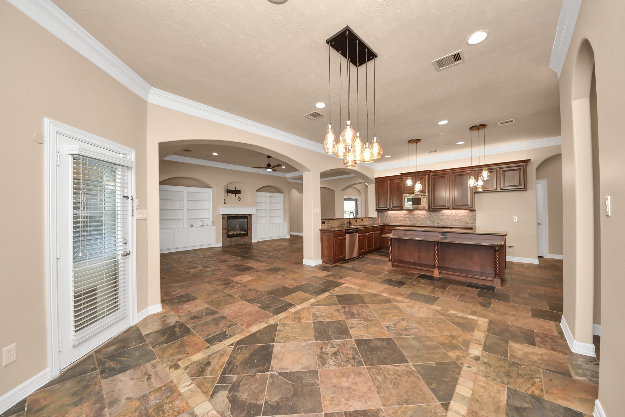 3511 River Bend Drive Rosenberg, TX 77471 - Photo 12 of 50 a living room with a dining table a chandelier and a view of kitchen