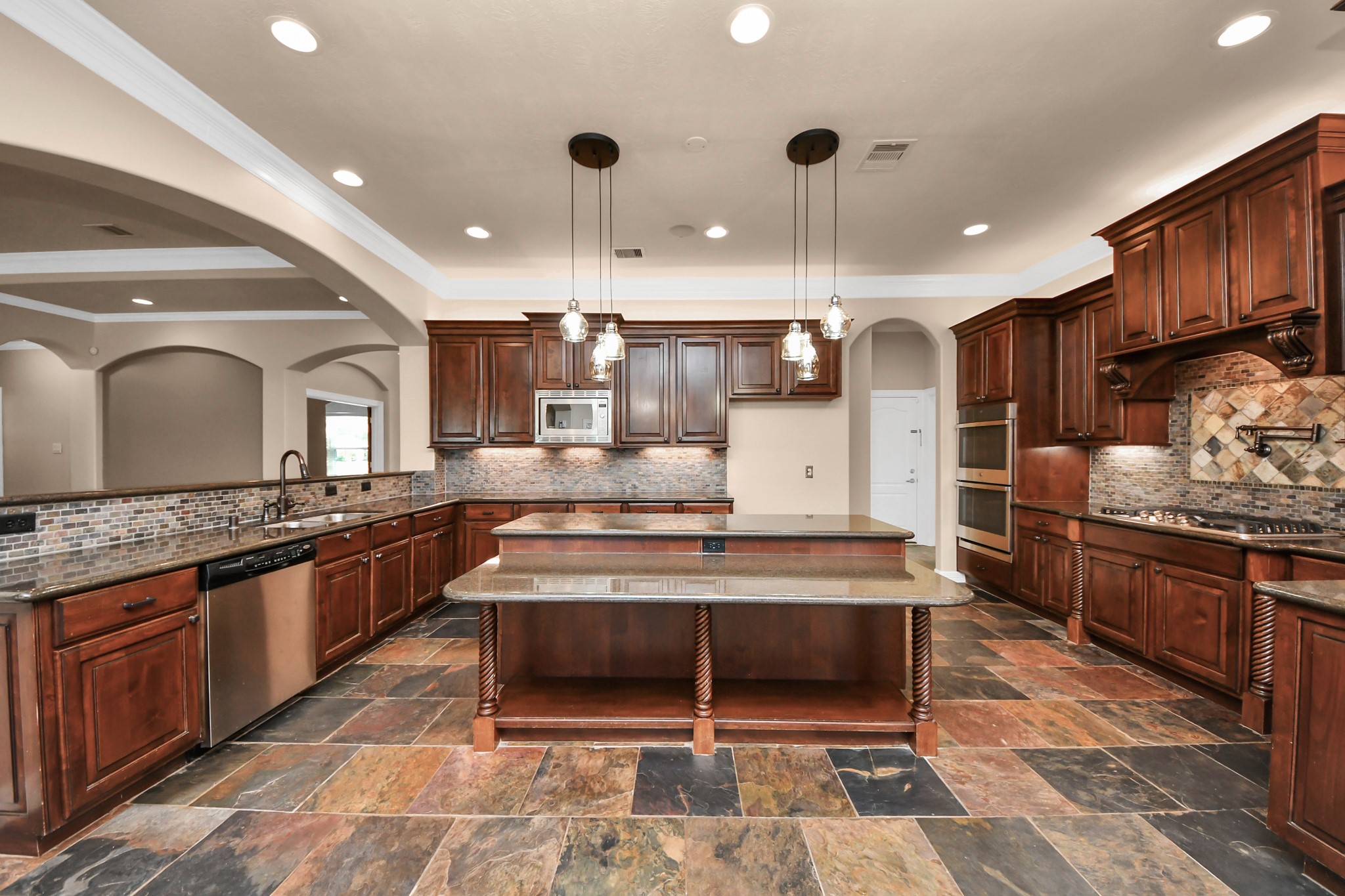 3511 River Bend Drive Rosenberg, TX 77471 - Photo 14 of 50 a large kitchen with stainless steel appliances kitchen island granite countertop a stove and a sink