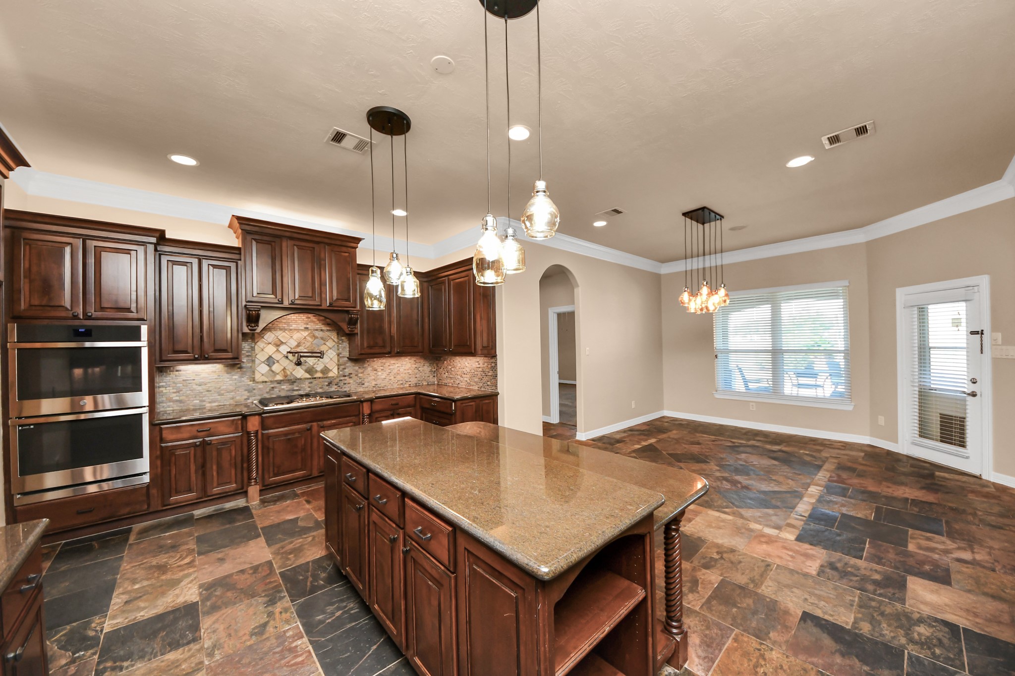 3511 River Bend Drive Rosenberg, TX 77471 - Photo 16 of 50 a kitchen with stainless steel appliances granite countertop a sink a stove and a wooden cabinets