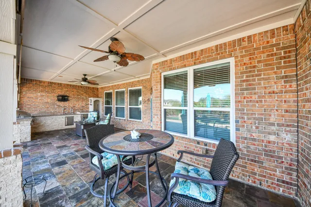 a view of a porch with furniture and wooden floor
