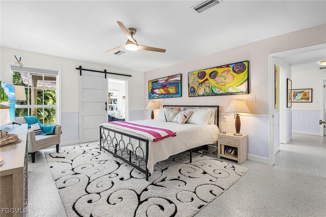 11860 Island Avenue Matlacha, FL 33993 - Photo 15 of 41 a bedroom with a bed a rug and a window