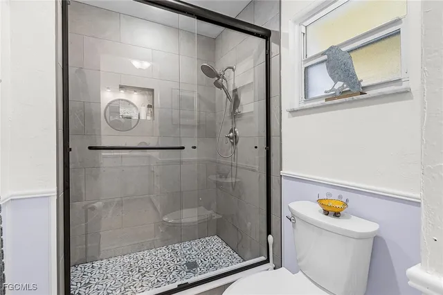 a bathroom with a granite countertop sink mirror and a shower