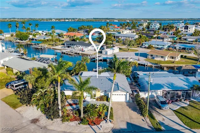 a front view of a house with garden space and patio