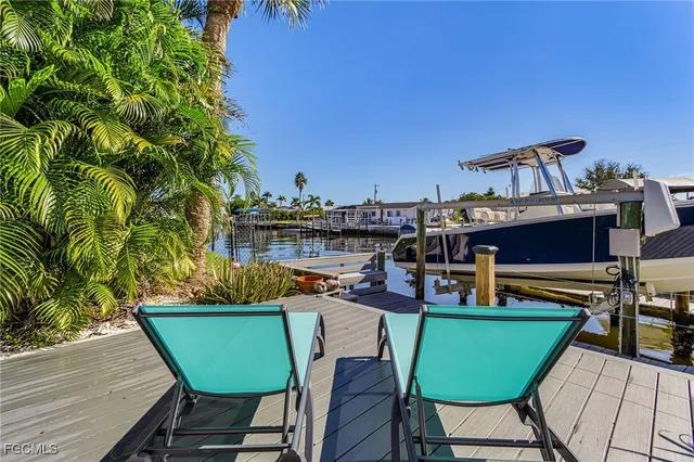 a view of a swimming pool with outdoor seating