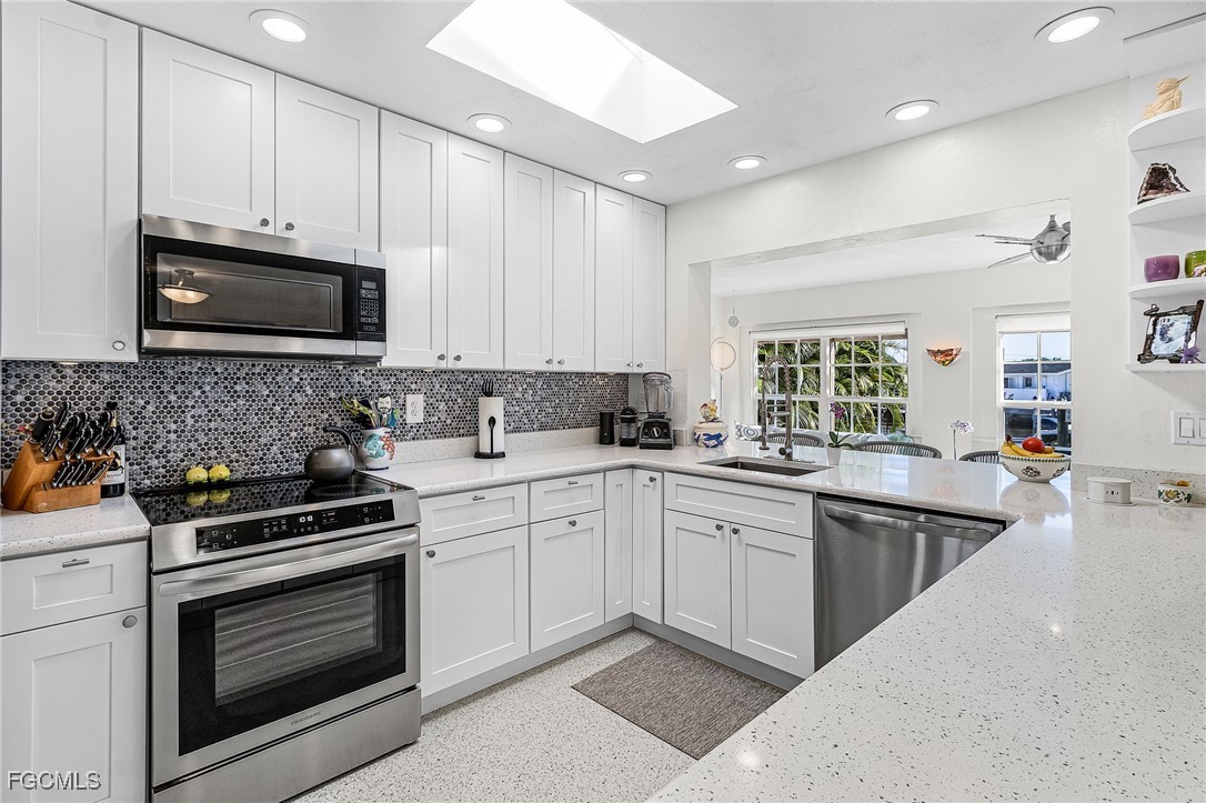 11860 Island Avenue Matlacha, FL 33993 - Photo 5 of 41 a kitchen with granite countertop a stove sink and cabinets