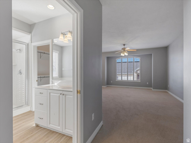 352 Haven Crest Road Draper, UT 84020 - Photo 27 of 44 Primary bedroom featuring neutral carpeting and an arched window with plantation shutters. en-suite