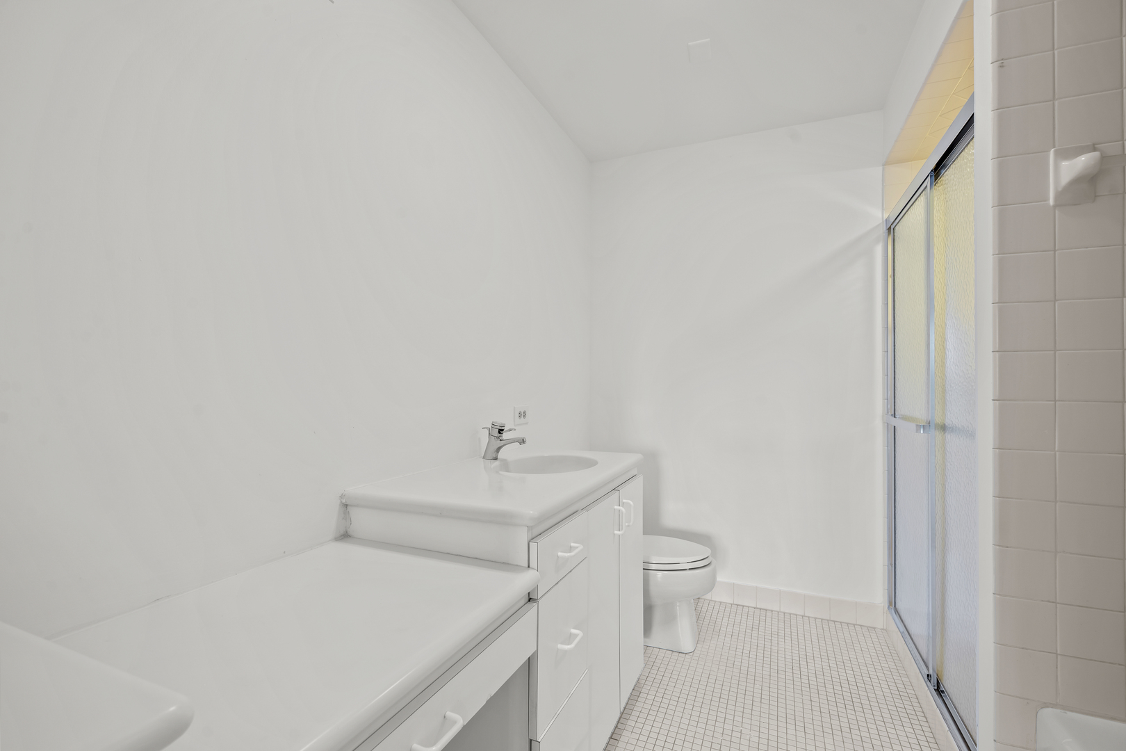 1125 Lake Cook Road, Unit 405 Northbrook, IL 60062 - Photo 12 of 18 a en suite bathroom with a sink a toilet and a shower