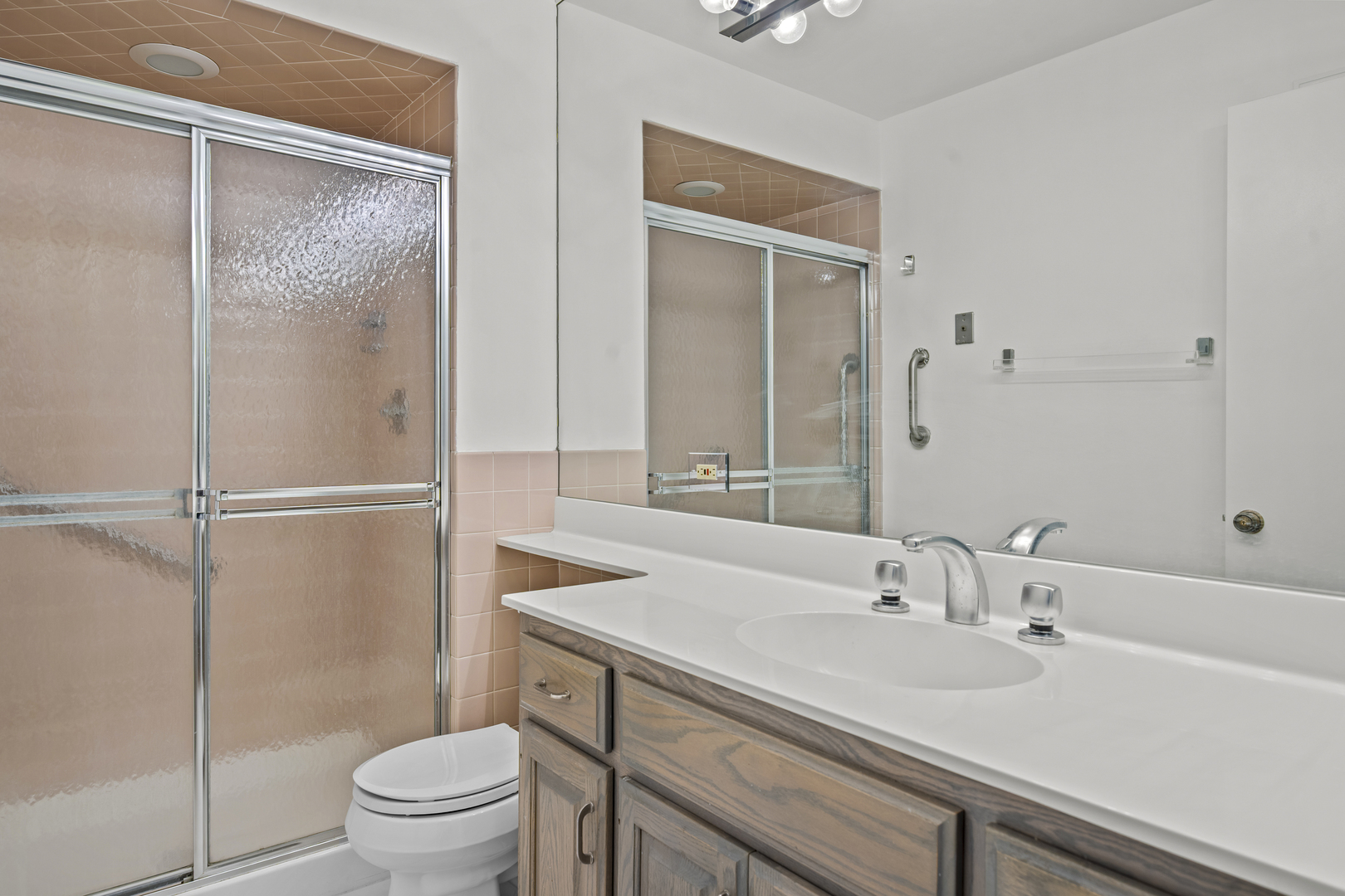 1125 Lake Cook Road, Unit 405 Northbrook, IL 60062 - Photo 15 of 18 a bathroom with a sink toilet and shower