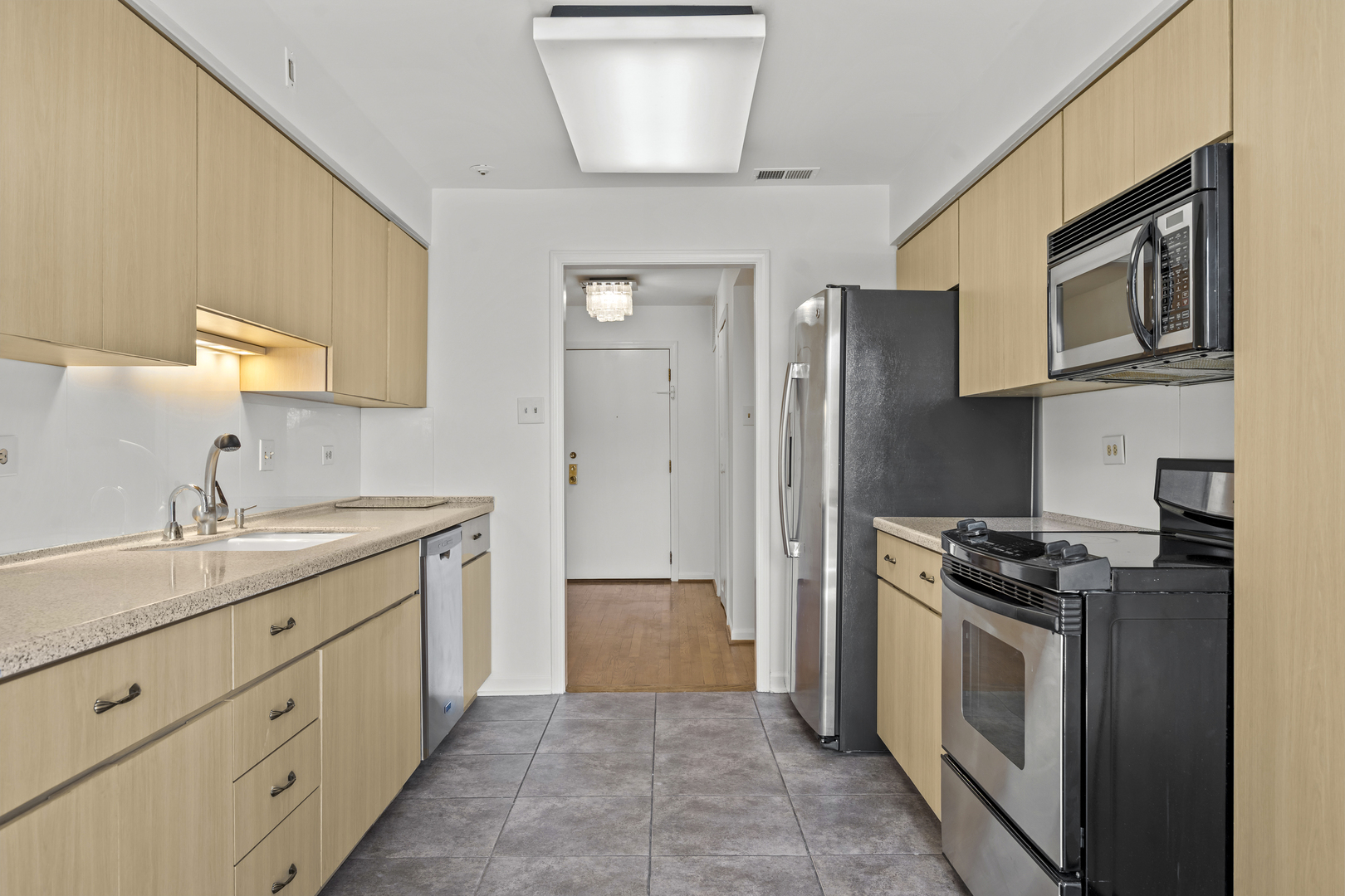 1125 Lake Cook Road, Unit 405 Northbrook, IL 60062 - Photo 8 of 18 a kitchen with stainless steel appliances granite countertop a stove a sink and a refrigerator