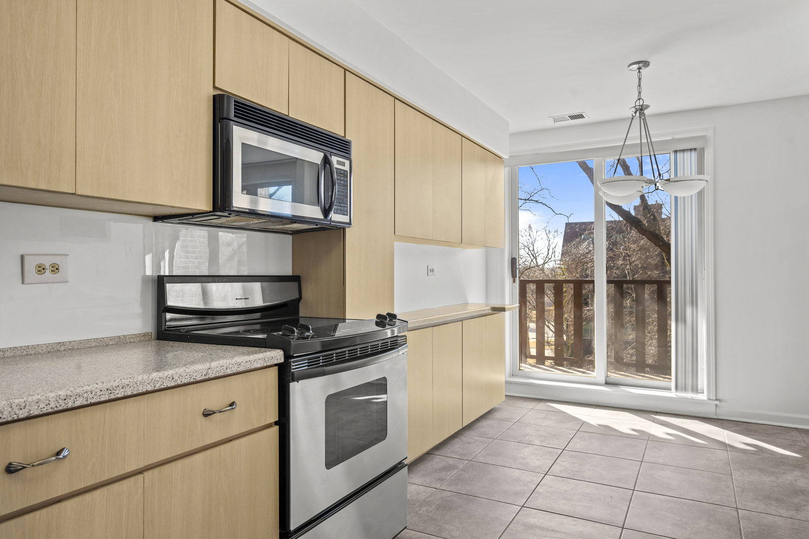 1125 Lake Cook Road, Unit 405 Northbrook, IL 60062 - Photo 10 of 18 a kitchen with stainless steel appliances granite countertop a stove a sink and a microwave