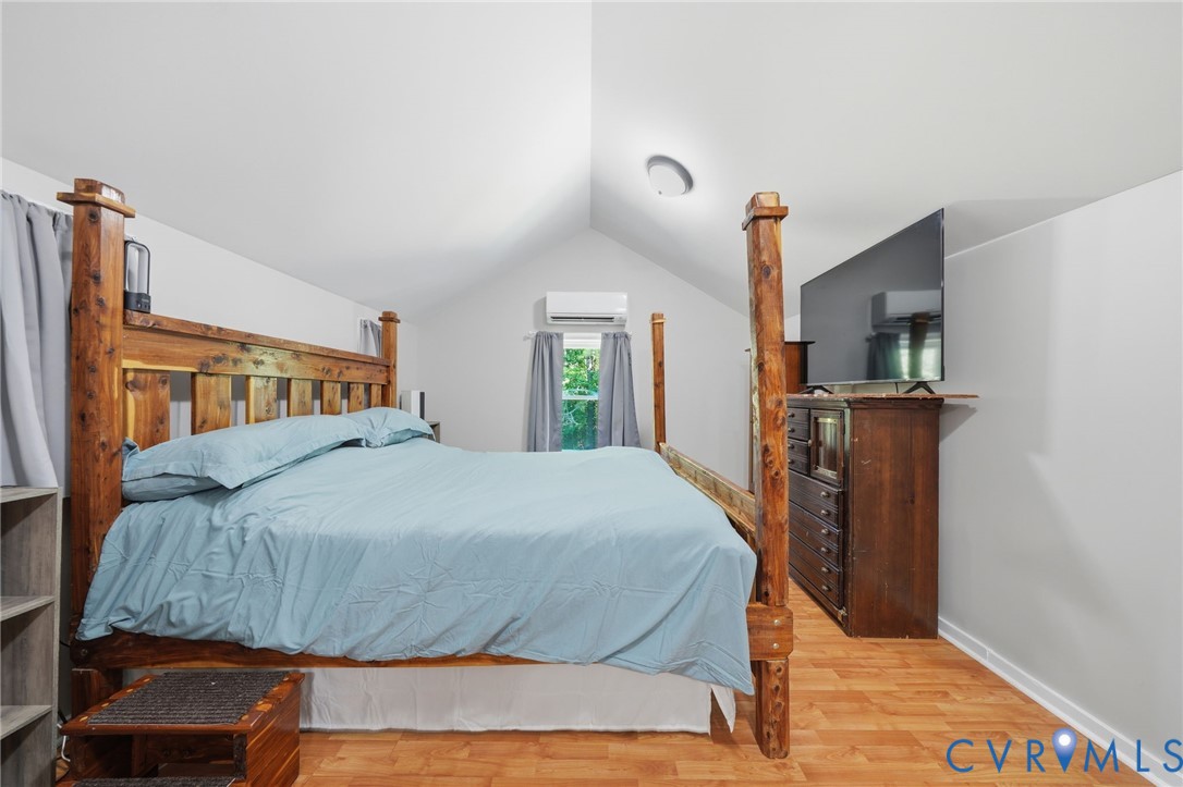 89 Old House Farm Road Bumpass, VA 23024 - Photo 32 of 67 Primary Bedroom Suite featuring a rustic wooden fo