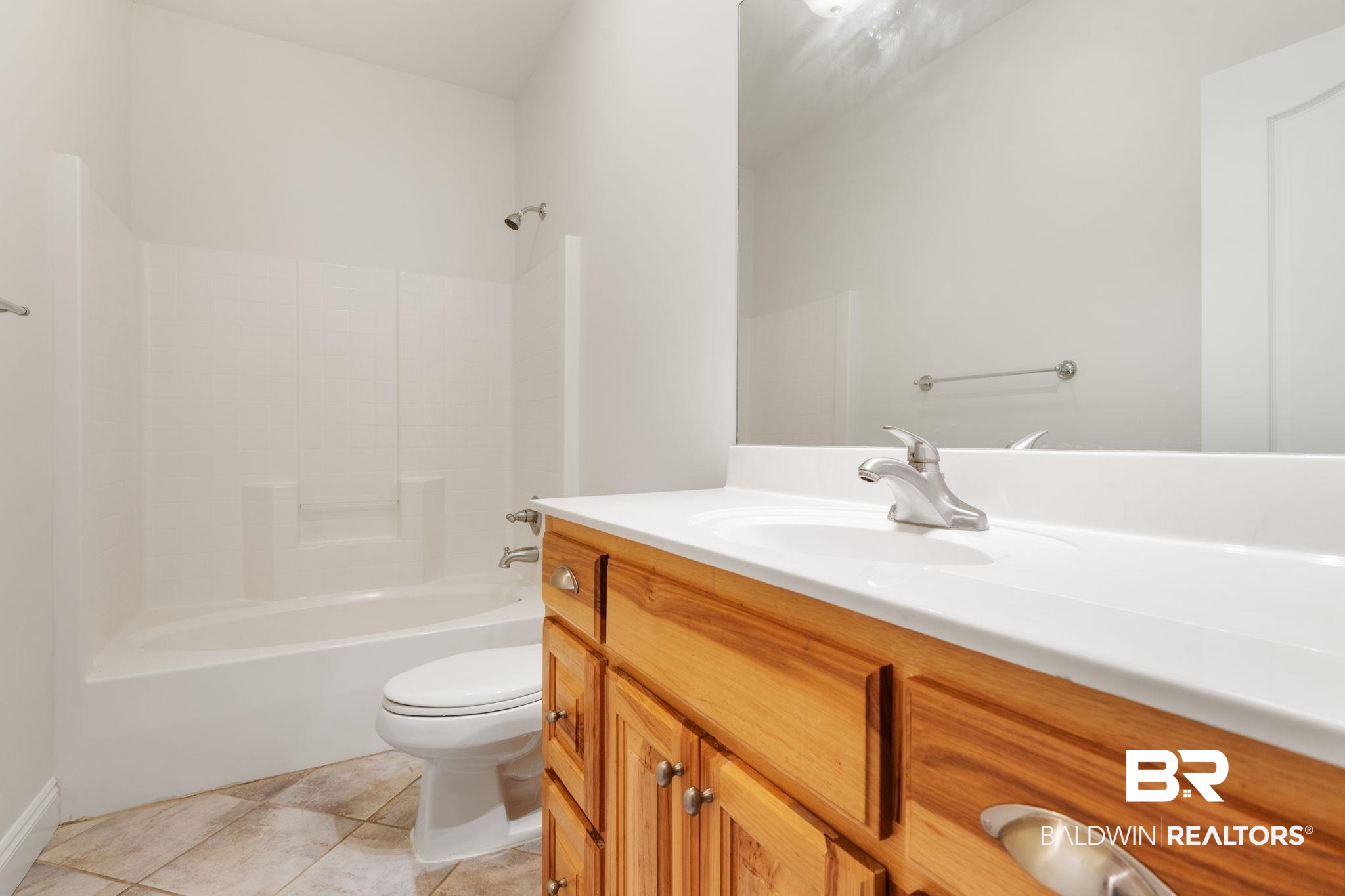 29634 St George Street Daphne, AL 36526 - Photo 27 of 47 Bathroom with vanity, light tile patterned flooring, and shower combination