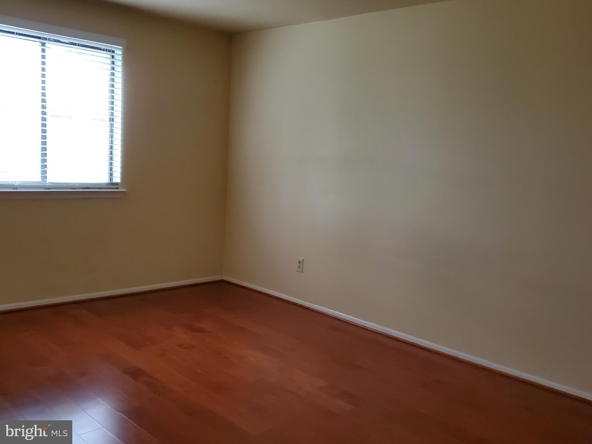 1002 Spring Gate Road, Unit 2C Baltimore, MD 21228 - Photo 6 of 12 an empty room with a window