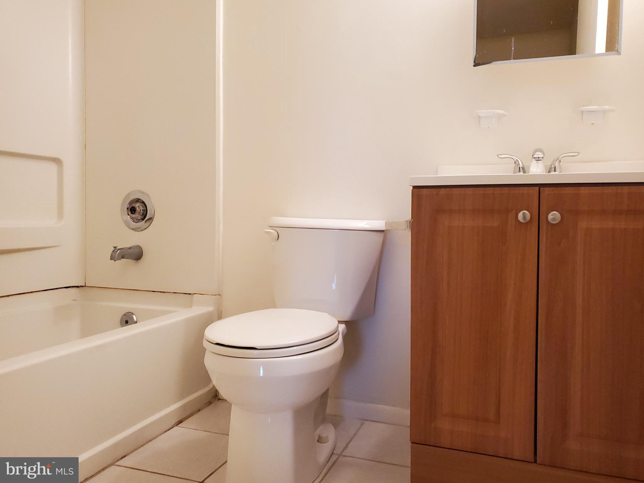 1002 Spring Gate Road, Unit 2C Baltimore, MD 21228 - Photo 9 of 12 a bathroom with a sink and toilet
