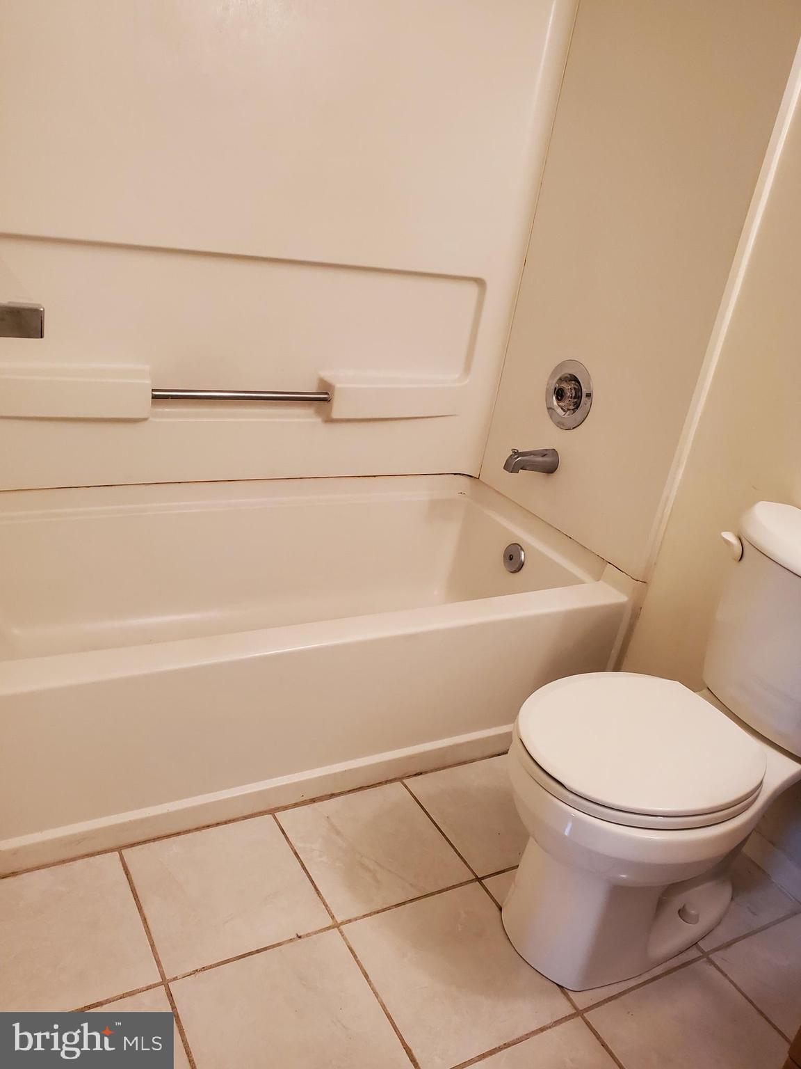 1002 Spring Gate Road, Unit 2C Baltimore, MD 21228 - Photo 10 of 12 a bathroom with a toilet and a bathtub
