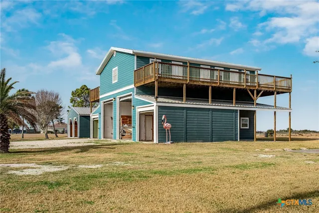 a view of a ocean with boats and trees in the background