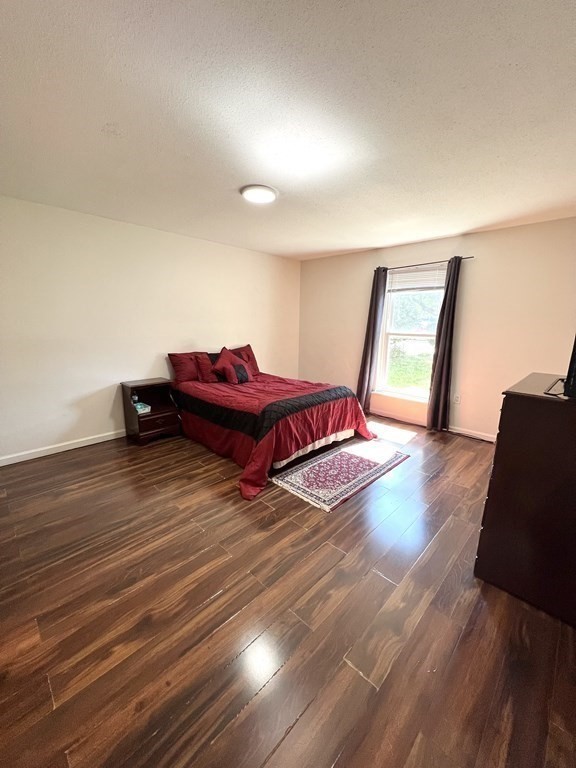 4 Shadowbrook Lane, Unit 6 Milford, MA 01757 - Photo 12 of 16 a room with a couch and wooden floor