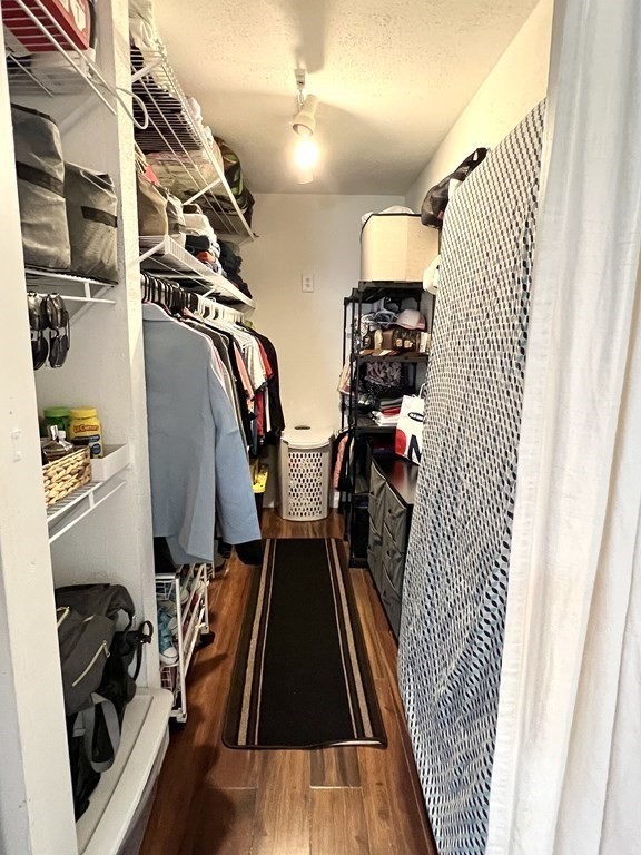 4 Shadowbrook Lane, Unit 6 Milford, MA 01757 - Photo 13 of 16 a view of walk in closet with clothes and shoes