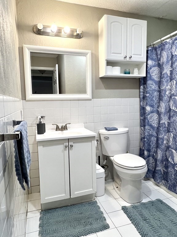 4 Shadowbrook Lane, Unit 6 Milford, MA 01757 - Photo 15 of 16 a bathroom with a sink toilet and mirror