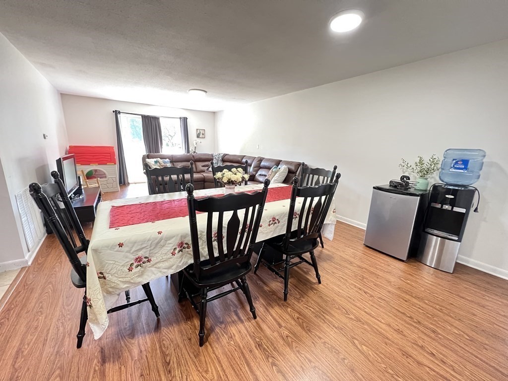 4 Shadowbrook Lane, Unit 6 Milford, MA 01757 - Photo 7 of 16 a view of a dining room with furniture and wooden floor