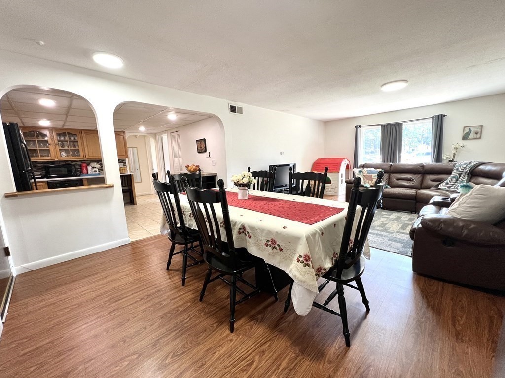 4 Shadowbrook Lane, Unit 6 Milford, MA 01757 - Photo 9 of 16 a view of a dining room with furniture and wooden floor