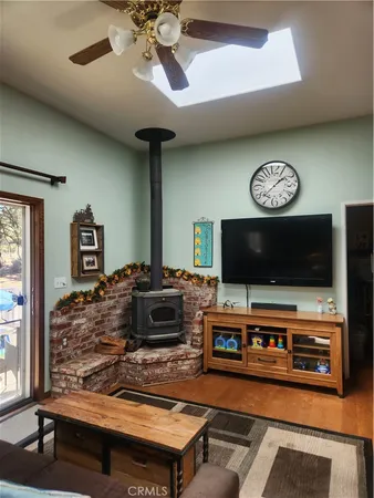 a living room with furniture a fireplace and a large window